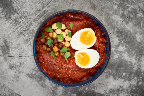 istock Shakshuka with chickpeas and boiled egg served in a blue bowl 2186875709