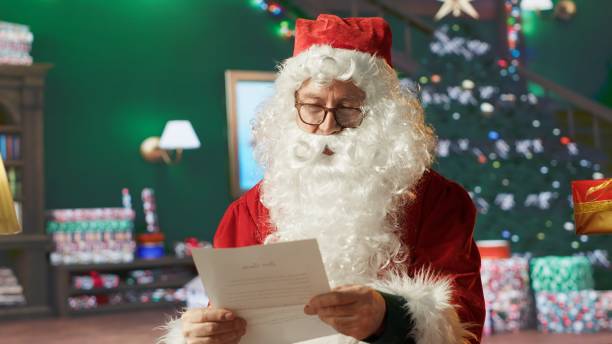 istock Saint Nicholas in his cozy log cabin reads wish lists and letters 2186875961
