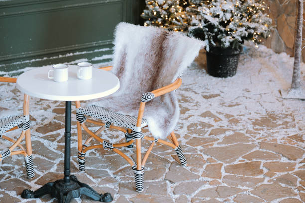 istock Cozy winter patio with a small table and mugs in a snowy setting 2186876681