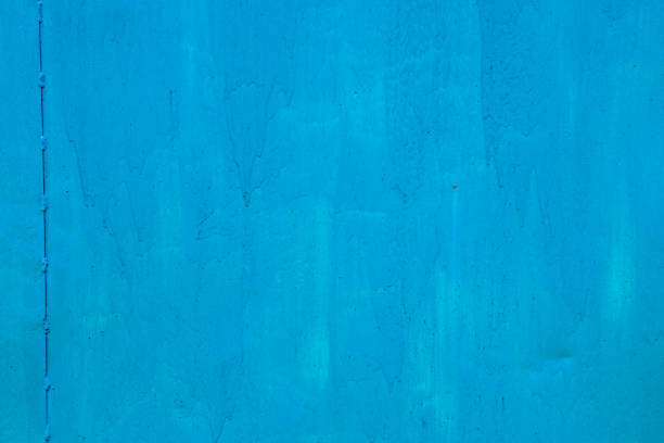 Old metal surface painted with blue paint. Copy space texture.