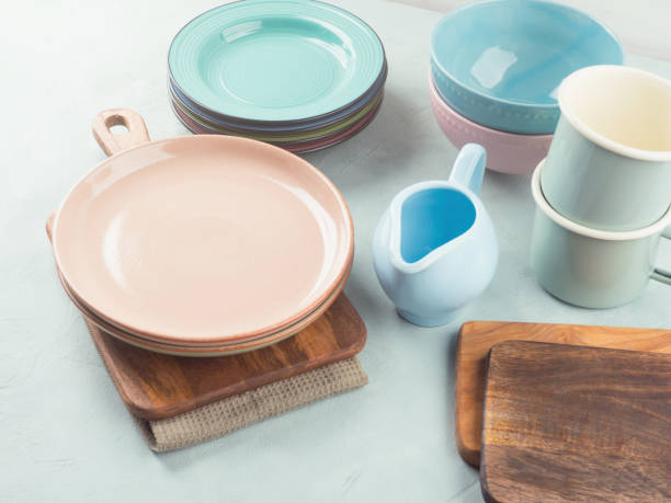istock Set of pastel pink, blue color tableware on turquoise background 2186876756