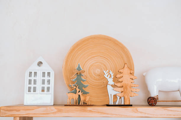 istock Artistic wooden decorations on a shelf featuring trees and reindeer 2186876810