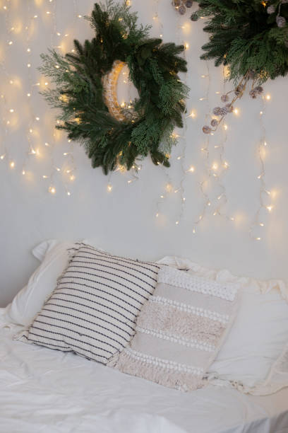 istock Cozy bedroom decorated with greenery and warm lights for a festive atmosphere 2186876881