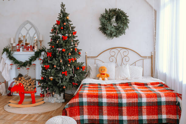 istock Cozy bedroom with Christmas tree and festive decorations during winter 2186876915