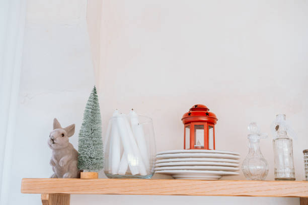 istock Decorative shelf arrangement with bunny figurine, tree, and elegant dishes 2186876969