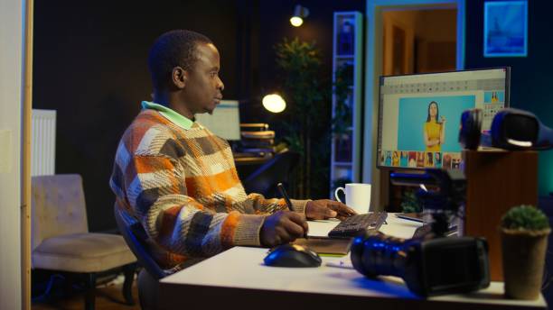 istock Skilled african american graphic editor retouching images on dual monitors 2186878768
