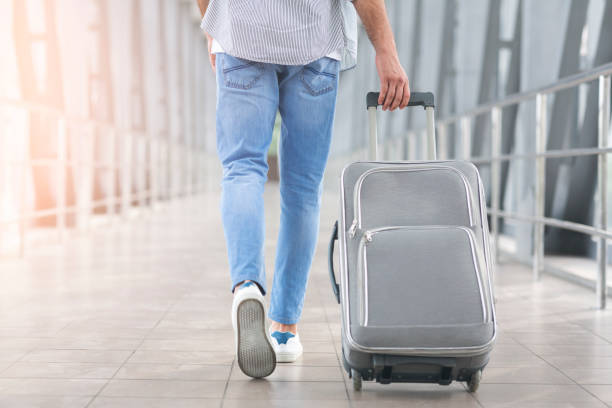 istock Weekend Trip. Unrecognizable Man Walking With Luggage In Aiport, Rear View 2186887570