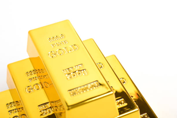 Stack of shiny gold bars isolated on white background, close up