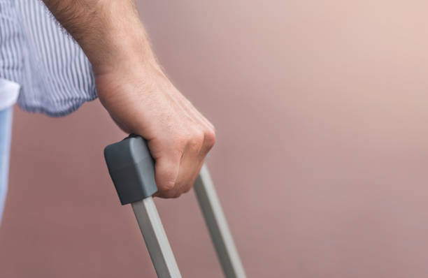 istock Closeup Of Male Hand Holding Suitcase Handle Outdoors, Cropped Image 2186888058