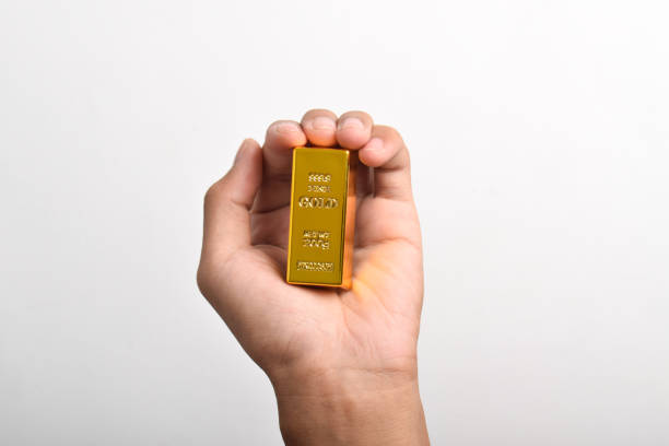 istock Hand holding Gold bar on white background 2186889953