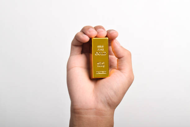 istock Hand holding Gold bar on white background 2186890021