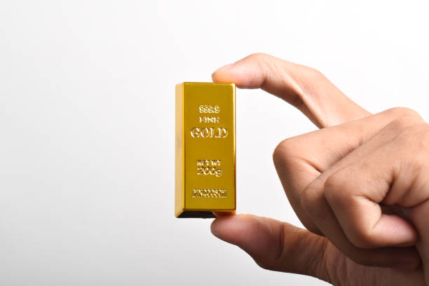 istock Close up of Hand holding gold bars 2186890241