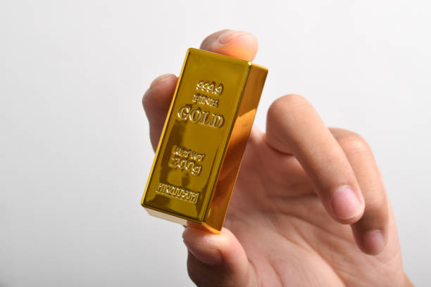 istock Hand holding Gold bar on white background 2186890381