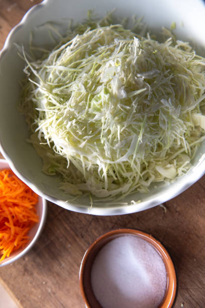 istock grated white cabbage and carrots and salt. Fermenting cabbage 2186892473