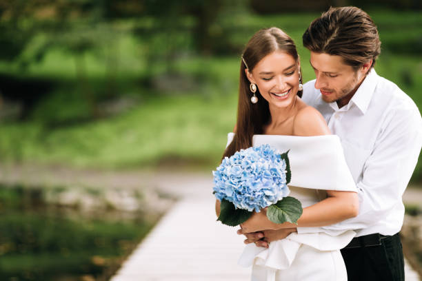 istock Wedding Couple Embracing In Park Having Minimalistic Just Us Ceremony 2186893819