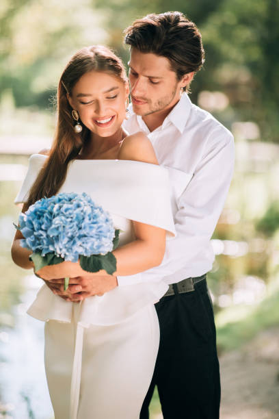 istock Just Married Couple Embracing Standing Outside, Vertical Shot 2186893821