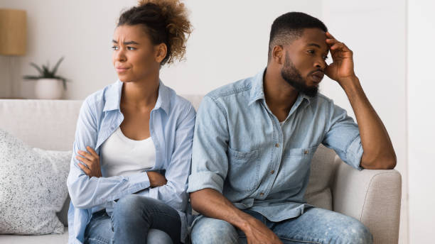 istock Sad african american couple sitting on couch looking away 2186894652