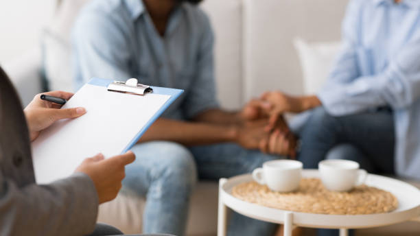 istock Unrecognizable Afro Spouses Talking Holding Hands On Marital Therapy Session 2186894677