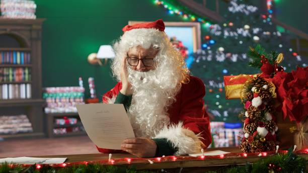 istock Traditional image of Father Christmas reading letters by the fire 2186897783
