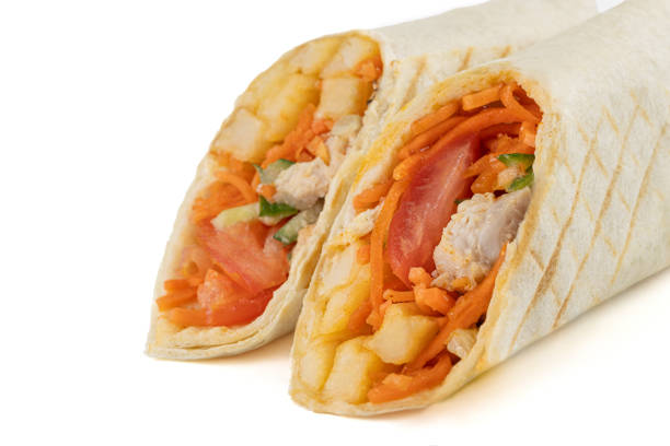 istock Burrito with chicken and vegetables cut in half. Close-up. macro photography. Isolate. White background 2186898109