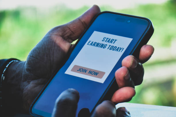 istock Man decided to join a mobile application to make money online. Digital display on smartphone, side hustle concept. 2186898217