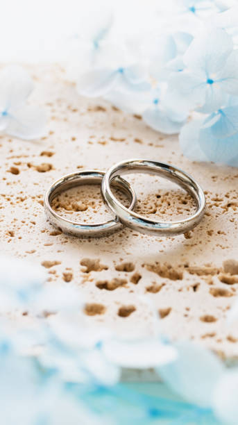 istock Wedding rings and light blue flowers. Stylish matching ring. Engagement ring. 2186900409