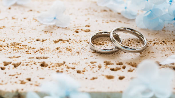 istock Wedding rings and light blue flowers. Stylish matching ring. Engagement ring. 2186900410