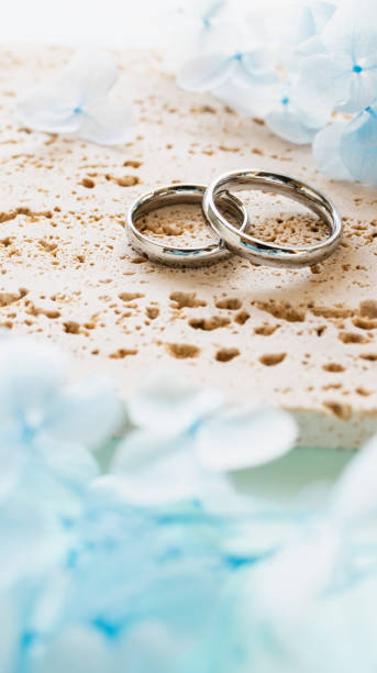 istock Wedding rings and light blue flowers. Stylish matching ring. Engagement ring. 2186900413