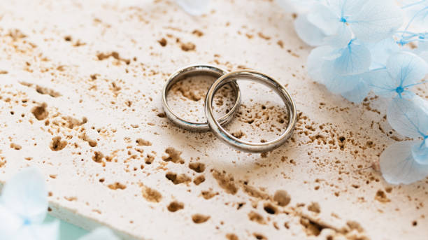 istock Wedding rings and light blue flowers. Stylish matching ring. Engagement ring. 2186900418