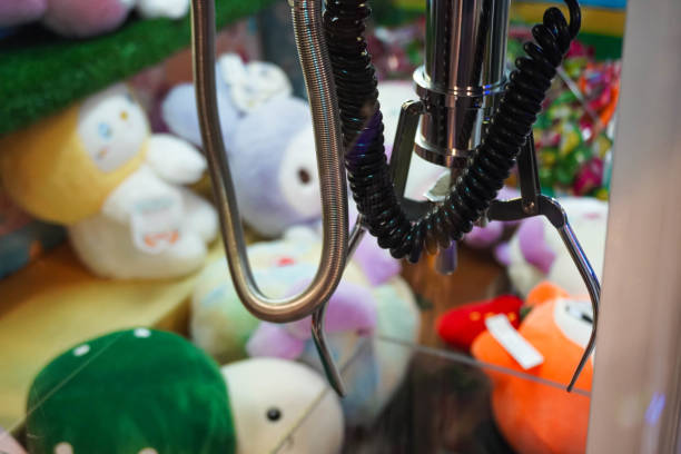 istock Doll picker or Claw clamp machine in game arcade. 2186902467
