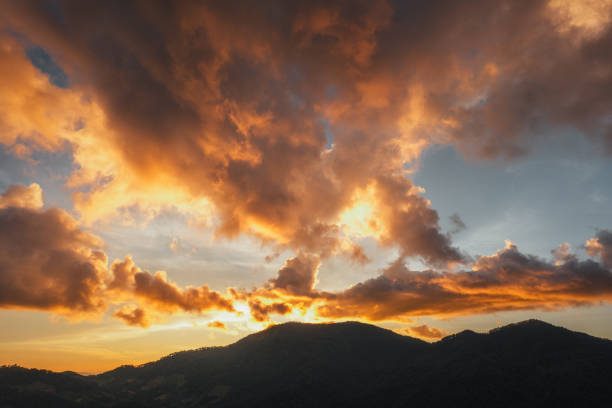 Golden clouds at dusk and mountains, evening clouds and sky background,