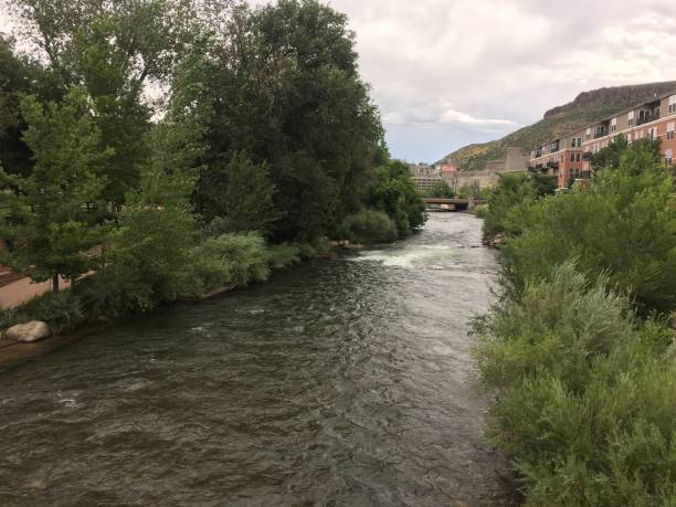 istock river running through a park with buildings in the background 2186906704