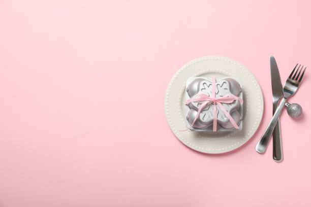 istock Plate, cutlery and box on pink background, space for text 2186907735