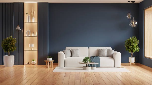 istock Living room with a white couch, a coffee table, and two potted plants on dark blue wall- 3D rendering 2186907928