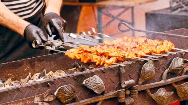 istock Hot street food. Kebabs sizzle on coals. Selective focus. 2186908340