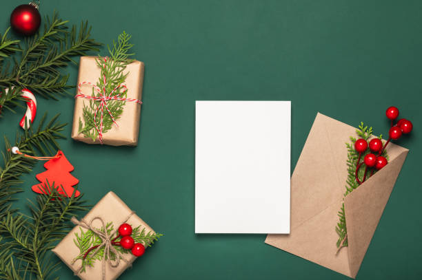 istock Christmas card, background. Paper gift boxes with thuja branches and envelope with empty card. Copy space. Boxing Day concept. 2186909589