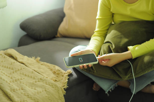 istock Woman hands Charging mobile phone battery with low battery 2186910077