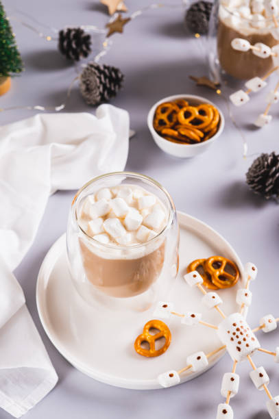 istock Hot chocolate with marshmallows and pretzels and snowflake on a plate vertical view 2186911015