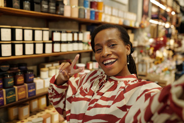 Smiling Woman Taking Selfie in Specialty Store