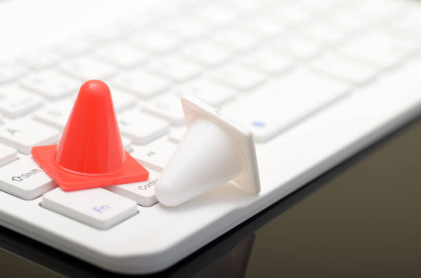 istock Safety Precautions and Work Efficiency Concept: Traffic Cones with Keyboard on Workspace 2186913706