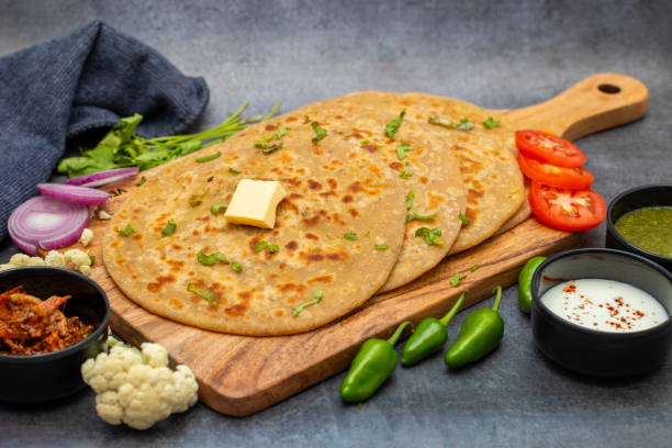 istock Gobi paratha is a popular Indian flatbread stuffed with spiced cauliflower, served warm with yogurt, pickles, or chutney. 2186914079