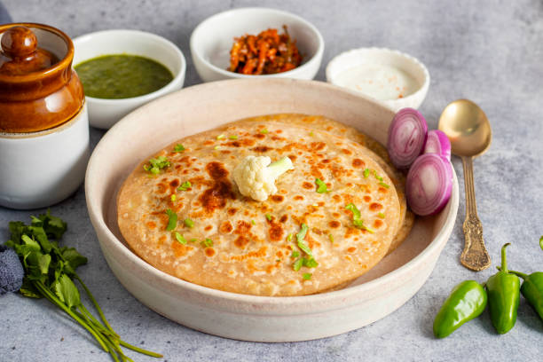 istock Gobi paratha is a stuffed Indian flatbread filled with spiced cauliflower, cooked on a griddle, crispy on the outside, soft inside. Delicious! 2186914498