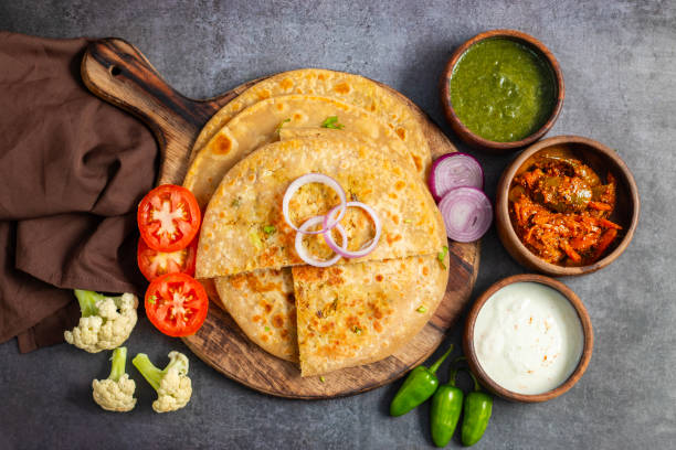 istock Gobi paratha is a traditional Indian flatbread stuffed with spiced mashed cauliflower, served hot with yogurt, pickles, or curry. Delicious and filling. 2186914913