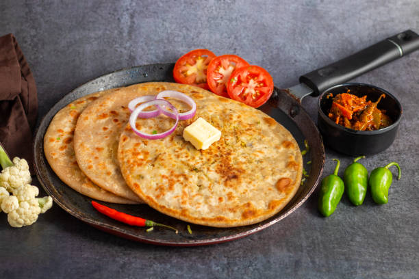 istock Gobi paratha is a popular Indian flatbread stuffed with spiced cauliflower, served warm with yogurt, pickles, or chutney. 2186914915