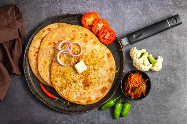 istock Gobi paratha is a stuffed Indian flatbread filled with spiced cauliflower, cooked on a griddle, often served with yogurt or pickles. 2186914917