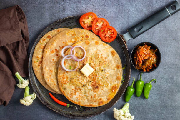 istock Gobi paratha is an Indian stuffed flatbread, made with spiced cauliflower filling, rolled into dough, and pan-cooked until golden and crispy. Often served with yogurt or pickle. 2186915032