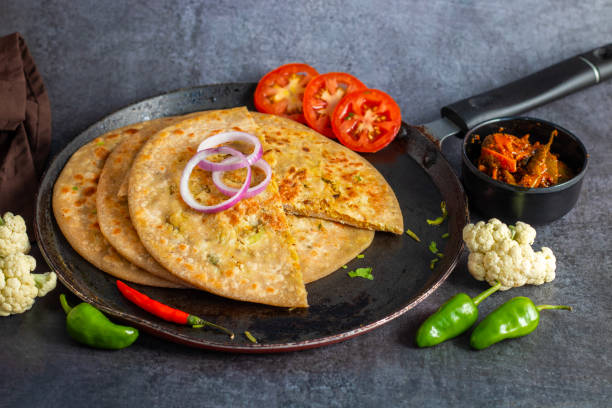 istock Gobi paratha is a stuffed Indian flatbread filled with spiced cauliflower, cooked on a griddle, crispy on the outside, soft inside. Delicious! 2186915034