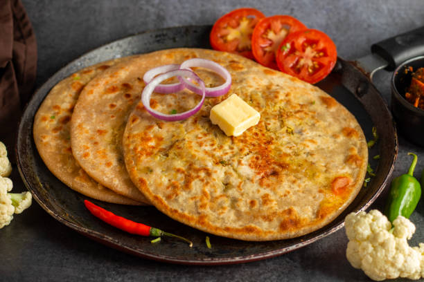 istock Gobi paratha is a traditional Indian flatbread stuffed with spiced mashed cauliflower, served hot with yogurt, pickles, or curry. Delicious and filling. 2186915036