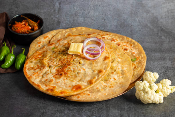 istock Gobi paratha is a popular Indian flatbread stuffed with spiced cauliflower, served warm with yogurt, pickles, or chutney. 2186915117