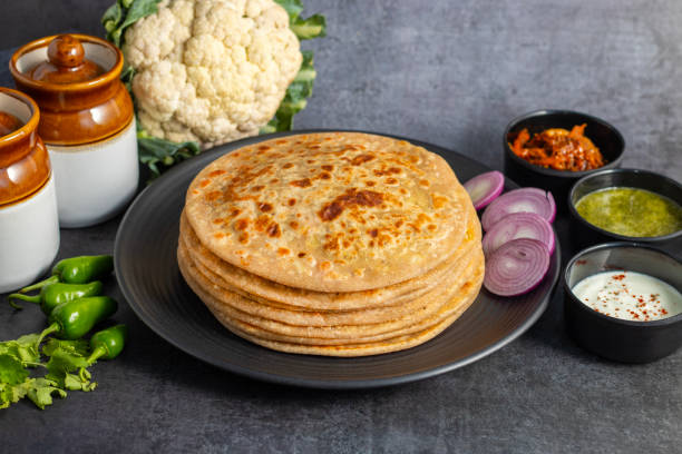 istock Gobi paratha is a stuffed Indian flatbread filled with spiced cauliflower, cooked on a griddle, crispy on the outside, soft inside. Delicious! 2186915153